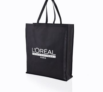 White logo printed black non-woven bag that says L'Oréal
