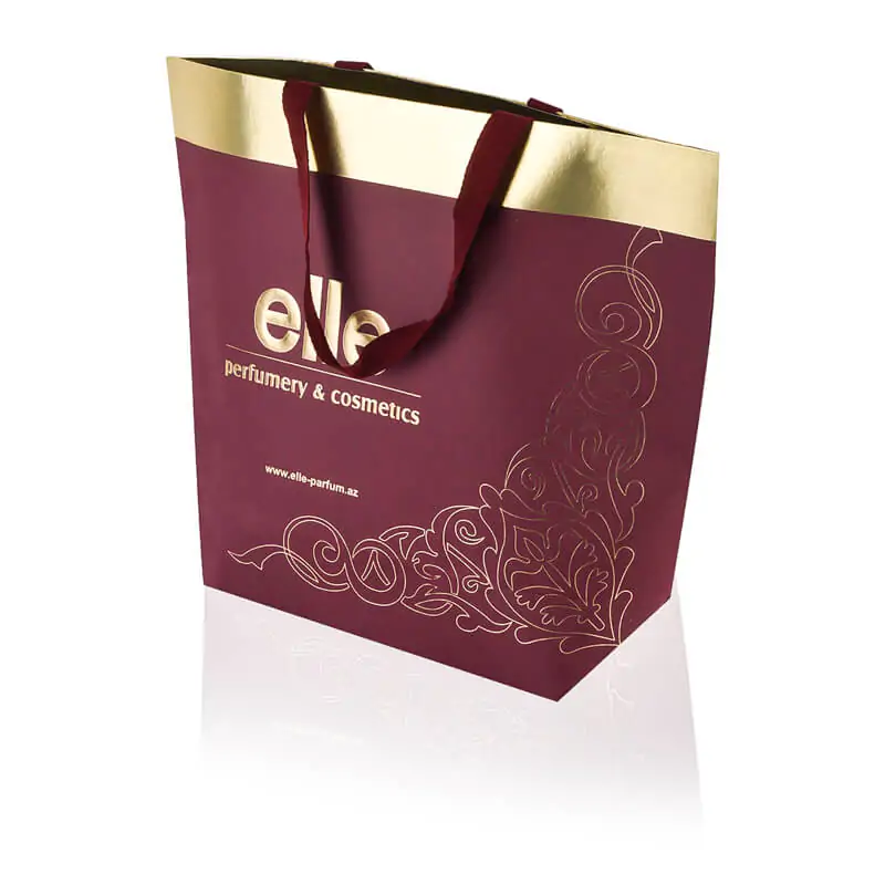 Bottom gusset burgundy unocated paper bag with metallic gold colour interior lamination and vanishing herringbone handle