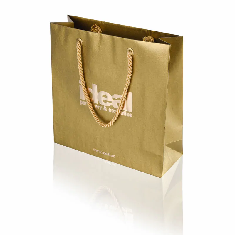 Special uncoated gold paper ultra luxury carrier bag with hot foil printing, gold twisted cord handle and metal eyelet