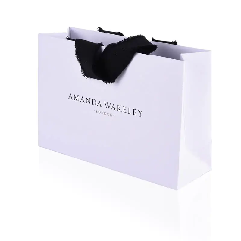 White uncoated grained luxury paper bag with frayed vanishing ribbon handle