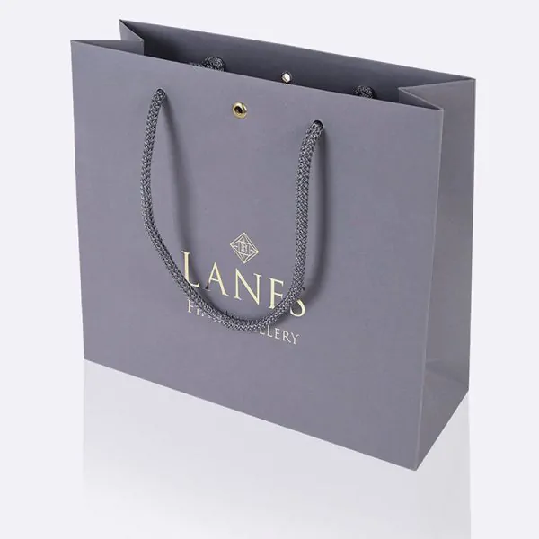 uncoated-grey-jeweller-paper-bag Grey pulp coloured uncoated luxury jeweller paper bag with hot foil printing and metal eyelet