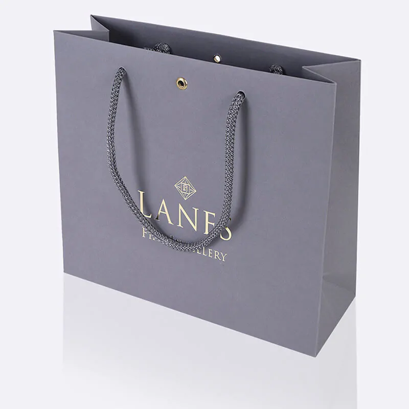 Grey pulp coloured uncoated luxury jeweller paper bag with hot foil printing and metal eyelet
