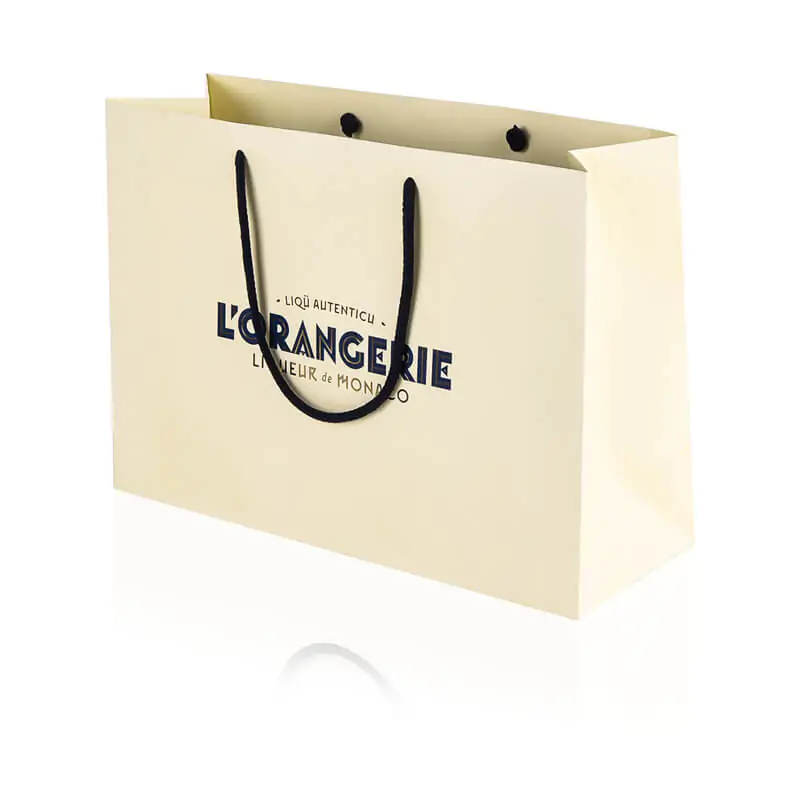 Matt laminated beige paper carrier bag with dark blue cotton handle and hot foil that says L'orangerie