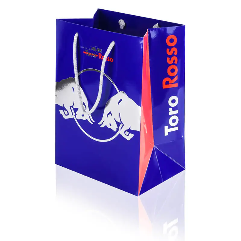 Blue Red bull luxury paper bag with silver hot foil printing that says toro rosso