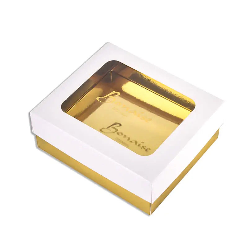 Lift off lid foldin carton with metallic gold lamination and clear window on the lid