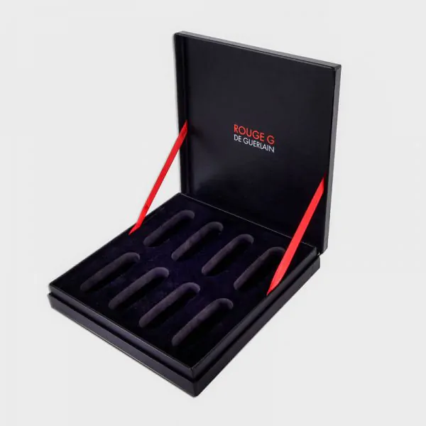 ribbon-hinged-black-box-eva Black higed rigid presentation box with red ribbon stop and eva insert that says guerlain
