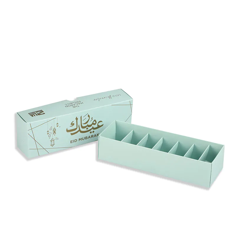 green macaron box with insert says eid mubarak